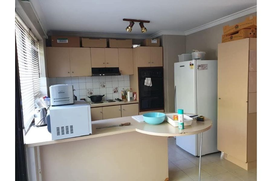 Dated beige kitchen before renovation in Perth