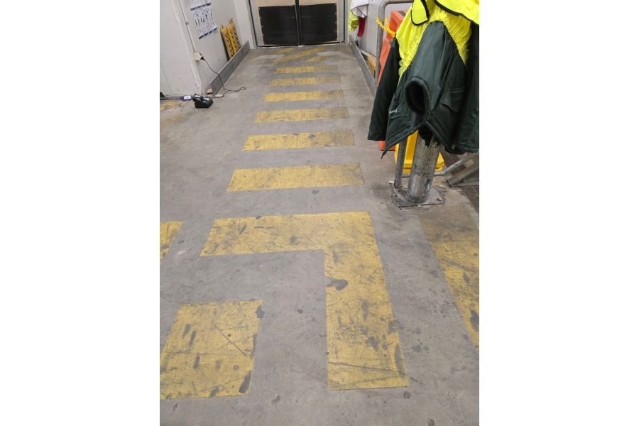 Faded and worn safety lines before restoration